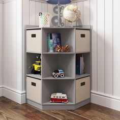 a toy car is sitting on top of a bookcase in the corner of a room