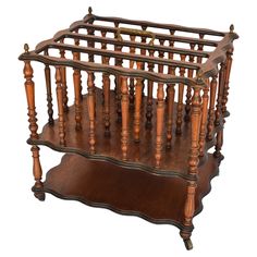 an old fashioned wooden cradle with spindles and wood posts on the sides, isolated against a white background