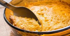 a close up of a casserole in a pot with a spoon sticking out of it