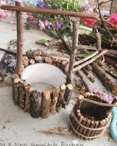 a pile of wood sitting on top of a table next to a vase and bowl