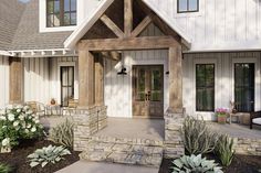 the front entrance to a house with landscaping around it