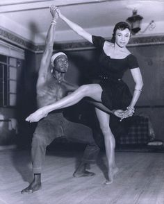 an old black and white photo of a man and woman in dance pose on the floor