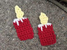 two crocheted red and yellow items sitting on the ground