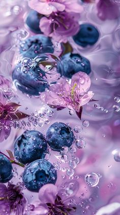 blueberries are floating in the water with purple flowers on them and bubbles around them