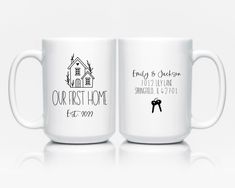 two white coffee mugs with the words our new home printed on them