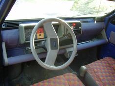 the interior of a car with its steering wheel and dash board showing, it appears to be in need of repair