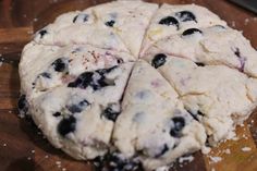 the dough has blueberries on it and is ready to be cut into pieces,