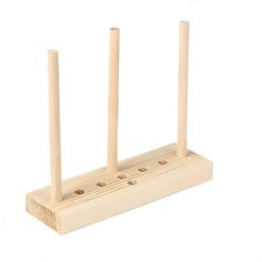 three wooden pegs on top of each other in front of a white background,