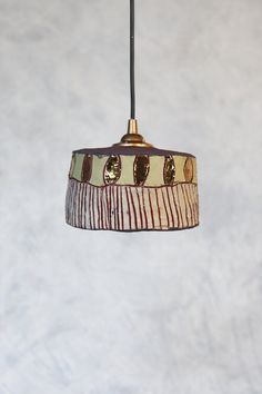 a lamp hanging from a ceiling in a room