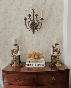 a table with some food on top of it next to two candelabras