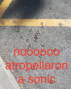 the words are written in red and black on the pavement with drops of water coming out of it