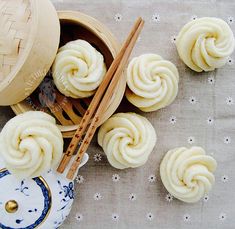 some food is sitting on a table with chopsticks