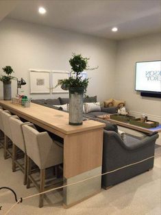 a living room filled with furniture and a flat screen tv mounted to the side of a wall