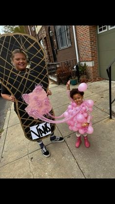 a woman and child are dressed up as skateboarders with pink pom poms