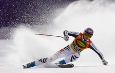 a man riding skis down a snow covered slope