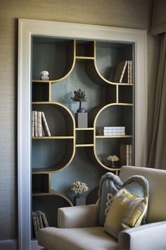 a living room filled with furniture and bookshelves on top of eachother