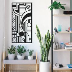 a plant in a white pot sitting on top of a wooden table next to a book shelf