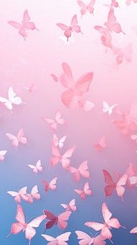 a group of pink butterflies flying in the air over a blue and pink sky background