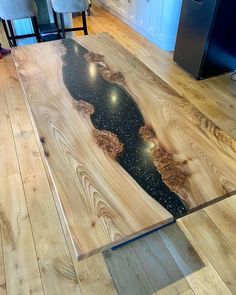 a table that has been made to look like wood with black and gold designs on it