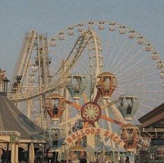 an amusement park with ferris wheel and rides