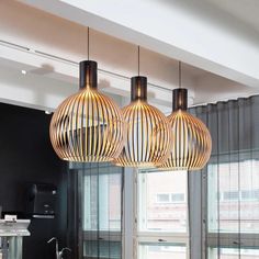 three lights hanging from the ceiling in a kitchen