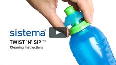 a hand holding a blue and green bottle with the word sistema on it