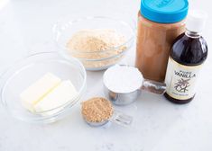 ingredients to make peanut butter and vanilla ice cream sitting on a counter top next to bowls