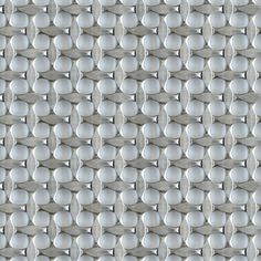 a close up view of the surface of a metal sheet with white circles on it