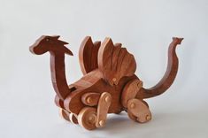 a wooden toy that is shaped like a dinosaur