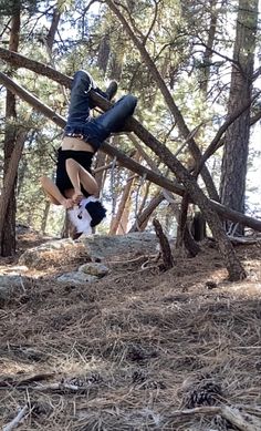 a man doing a handstand in the woods