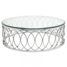 a round glass table with metal frame and circular design on the bottom, in front of a white background