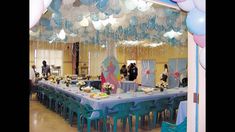 a party hall with balloons, tables and chairs