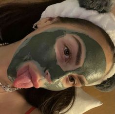 a woman with a green mask on her face