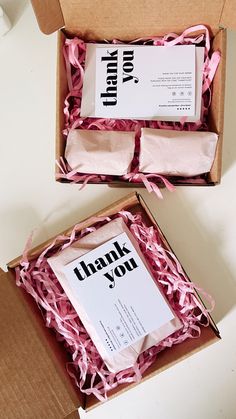 two open boxes with thank you cards inside one is pink ribbon and the other is brown paper