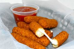 fried food item in basket with ketchup and sauce