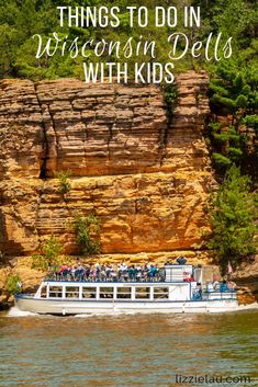 a boat with people on it in front of some cliffs and trees, text reads things to do in wisconsin dells with kids