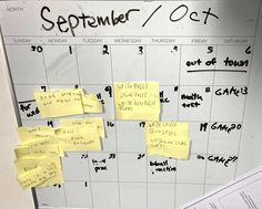 several sticky notes are pinned to a calendar