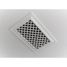 a white ceiling vent with black squares on it