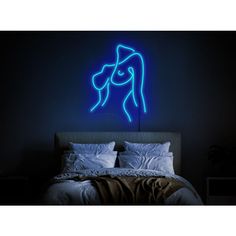 a blue neon sign on the wall above a bed in a room with black walls