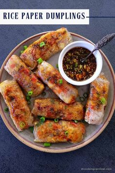 rice paper dumplings on a plate with dipping sauce and green onion garnish