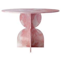 a pink marble table with two circular bases