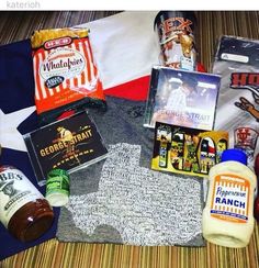 an assortment of items are laid out on top of a table with the american flag in the background