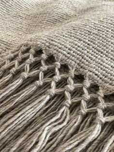 the texture of a blanket with fringes is shown in this close up photo,