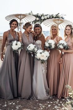 a group of women standing next to each other under an umbrella