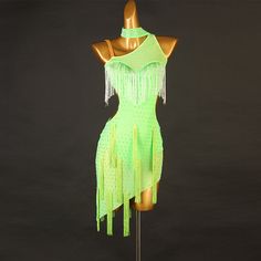 a mannequin wearing a neon green dress with fringes