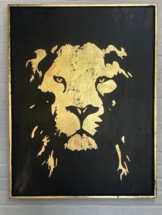 a black and gold lion painting on a brick wall