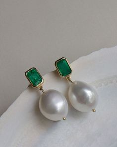 These earrings feature one-of-a-kind baroque pearls and Zambian emeralds. Baroque pearls are naturally formed and each is unique. Our emeralds are 100% natural, meaning they're not dyed or heat treated. No stone is exactly alike. 14k solid gold—always. Weight: 3g per earring Carat weight: 0.5cw per earring Stone Measurements: 6mm x 4mm Pearl Measurements: Approx 13mm x 12mm Pearl & Emerald Care: Pearls and emeralds are not meant to be worn in the shower. To extend the life of your piece, we reco Pearl Emerald Earrings, Green Gemstone Pearl Drop Earrings, Green Gemstone Drop Pearl Earrings, Elegant Green Pearl Earrings With Charm, Elegant Green Pearl Charm Earrings, Green Pearl Drop Earrings, Emerald Earrings With Pearl Drop For Gift, Green Emerald Earrings With Pearl Drop, Pearl Drop Earrings For May Birthstone