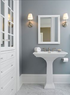 a bathroom with gray walls and white fixtures on the bottom right hand corner is an instagram post about paint colors