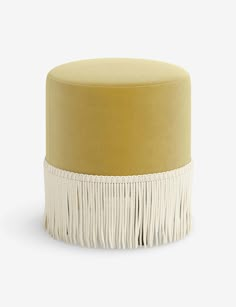 a yellow and white ottoman with fringe trim