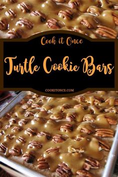 a cookie bar with caramel drizzle and pecans on top in a pan